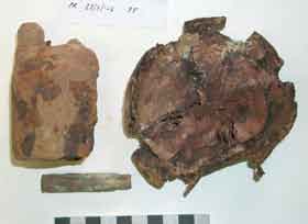 An armoured breastplate, some shells, entrenching tools, a helmet, a water bottle and a beaker found by a local