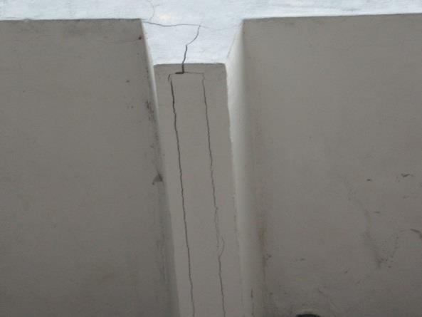 a. Roestende staalconstructie en wapening: Schade schuine opstand balkonvloer (kim): Dit is schade van roestende wapening in de schuine opstand van de betonvloer naar het metselwerk.