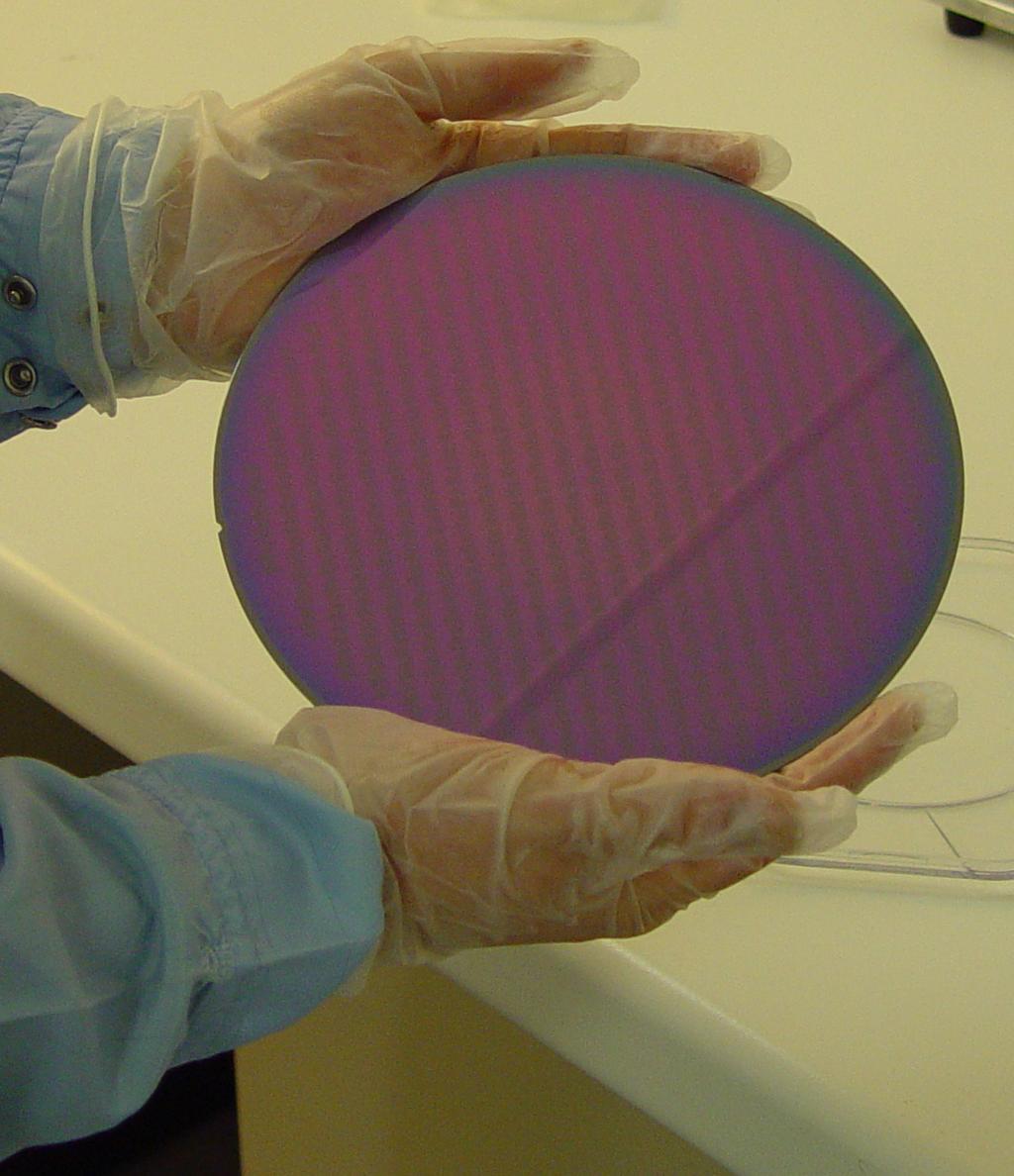 10 Coupling light from fibres to nanophotonic waveguides Figure 2.1: A lot of photonic integrated circuits fit on a 200 mm SOI wafer.