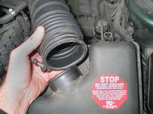 Disconnect the negative terminal from the vehicle battery. 2. Unclip & remove the intake hose from the air box lid. (Fig.