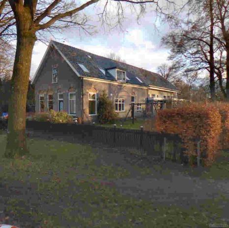 Schoolstraat 1 Krimpenboerderij met rietgedekte nieuwe schuur, sobere Interbellumarchitectuur, 1921. Van belang vanwege de ruimtelijke situering, de hoofdvorm en het voorhuis.