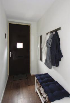 55, L-vormige woonkamer met grote schuifpui naar het terras en toegang tot de trapkast en trapopgang naar de verdieping.