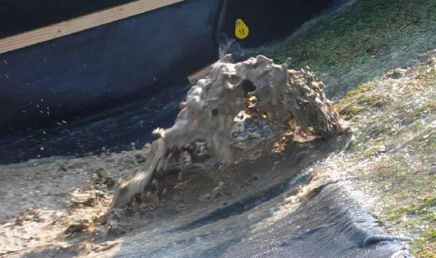 Het optredend verhang kan worden geschat door het verschil tussen de grondwaterstand in de zandkern en de ligging van de bovenkant van het uittredekanaal, gedeeld door de lengte van het