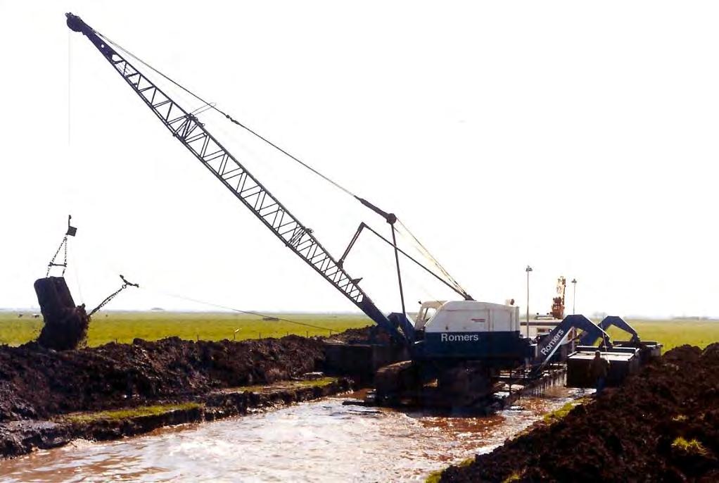 geplaatst is op een ponton die in de uitgegraven sleuf drijft (zie foto B2.5). De teelaarde wordt separaat in depot gezet. Figuur B2.