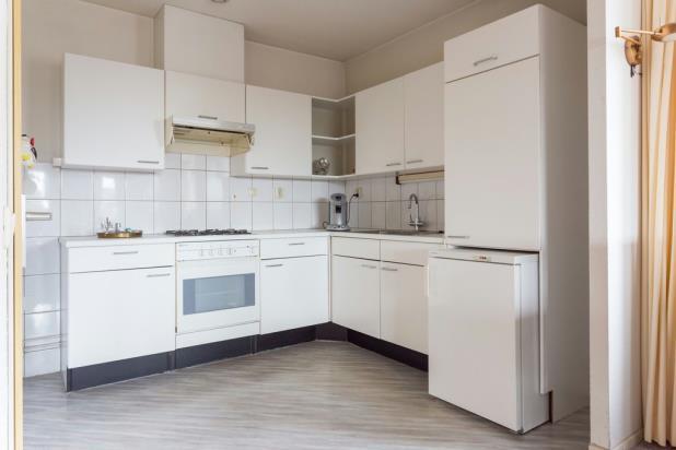 De open keuken, uitgevoerd in een lichte kleurstelling, is voorzien van diverse een koelkast,