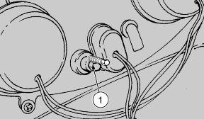 To adjust the light beam: Rest the vehicle on its stand. Working from the bottom side of the windscreen, operate on the knob (1). TURN IT CLOCKWISE to raise the light beam.