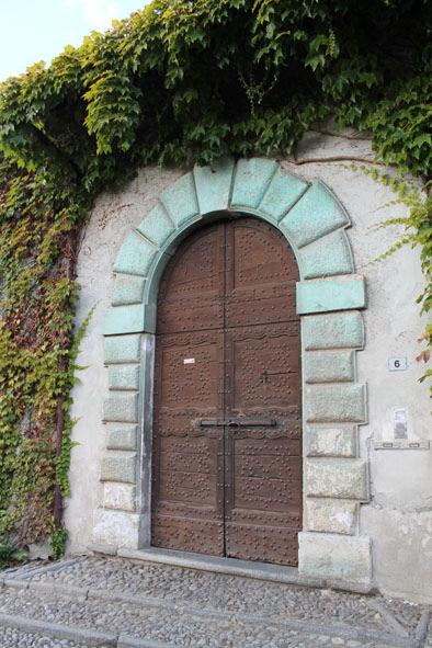 Bij de T-splitsing, waar op de hoek links een fonteintje staat, gaan we rechtsaf langs het palazzo Torri met zowel links als rechts een fraaie toegangspoort met een granieten boog.