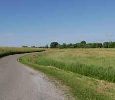 goede inpassing tankstation en golfbaan in landschap.