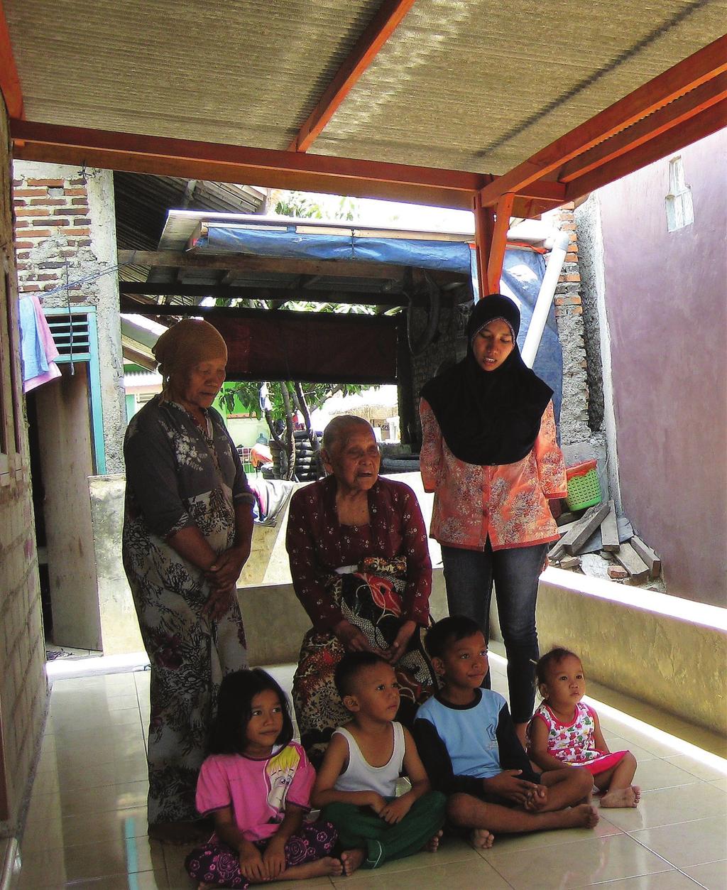article artikel Ibu Tijeng (1927 2018) samen met haar familie voor het nieuwe huis dat ze bouwden met