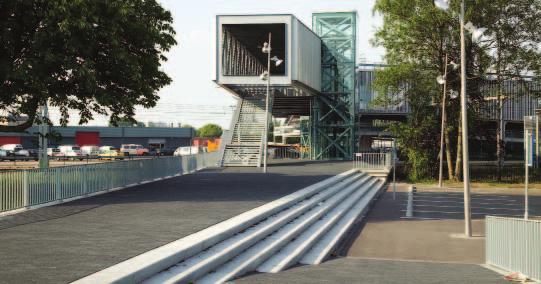 De looproute tussen brug en perron is los gehouden van het drassige maaiveld door deze op te sluiten tussen betonnen keerwanden.