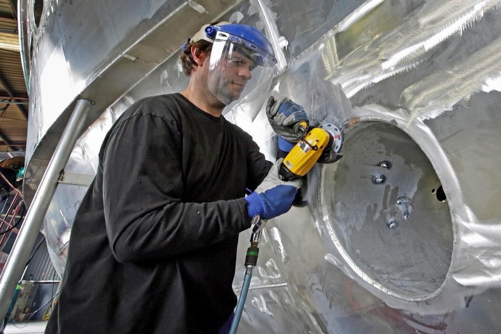 Van-der-Valk-werf: Productiviteitsverbetering in handgestuurde aluminiumverspaning 8/8 Maarten Rijken bewerkt aluminium lasnaden bij de opening voor het boegstraalroer van een 27 meter lang volledig