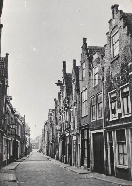 Afb. 7. De Kolfstraat tussen 1953 en 1957, vóór de grootschalige sloop van de huizen gezien in de richting van de Vest (achtergrond).