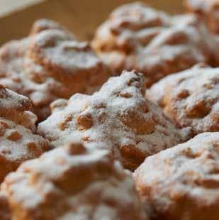 Spuit de koekjesspijs op bakpapier in een hoefvorm en druk 2 halve amandelen in het koekje. Til het bakpapier op en leg deze omgekeerd in de grove suiker voor het bakken.