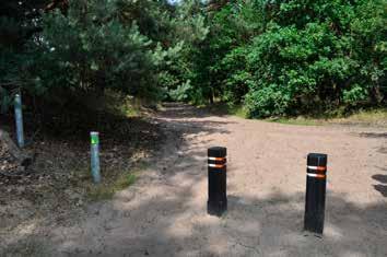 28 Loop voorbij de ijzeren slagboom. 29 Ga op de viersprong rechts. Volg steeds de paaltjes. 30 Op de driesprong gaan we naar links.