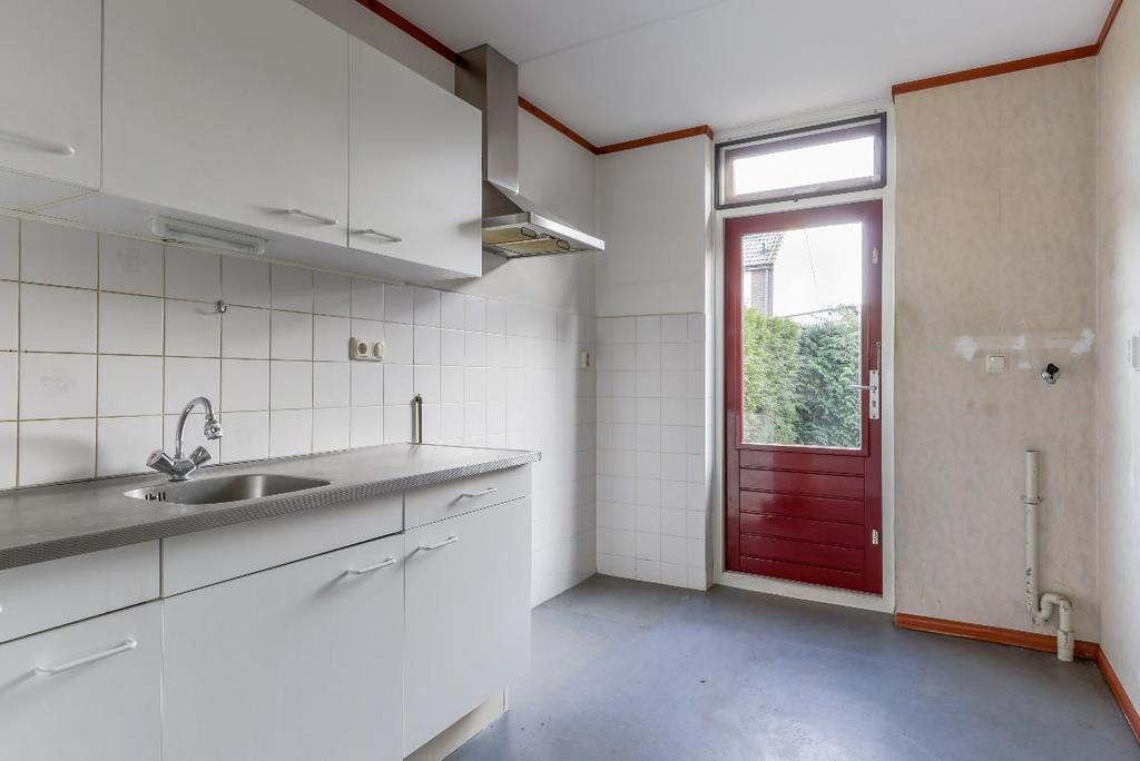 - De ruimte is voorzien van een eenvoudig, recht keukenblok in een lichte kleurstelling zonder inbouwapparatuur.