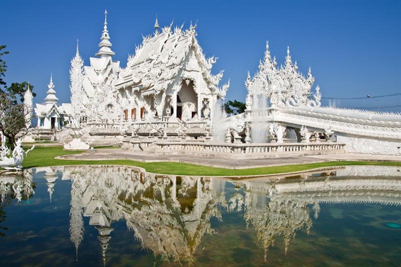 Via een door draken geflankeerde trap van 300 treden leg je het laatste stukje naar de tempel af, samen met de Thai die hier komen om te bidden.