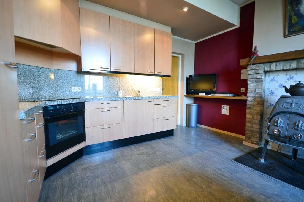 De keuken (17 m²) in hoekopstelling is voorzien van een 4 pits inductie kookplaat, afzuigkap, oven,