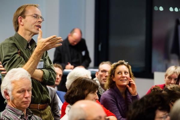 Ferdi Licher (links) in gesprek met kamerleden Albert de Vries (midden) en Roald van der Linde (rechts). Walter de Vette van Mitros stelt een vraag over de de begrenzing van de STEP subsidie.