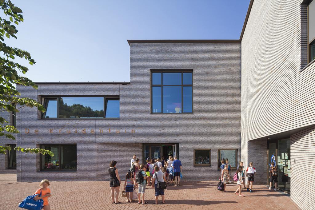 Aan de doorgaande weg toont het gebouw zijn