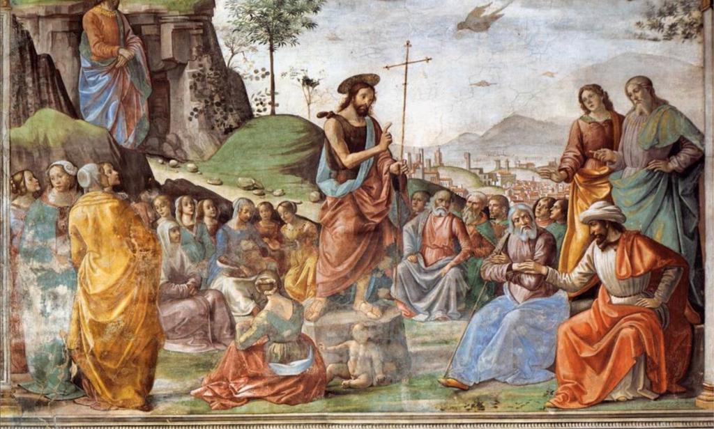 Johannes predikt tot de menigte In het midden staat een man op een boomstam/rotsblok. Hij heeft een rood met blauw gewaad aan. Zijn haar is lang en hij heeft een baard.