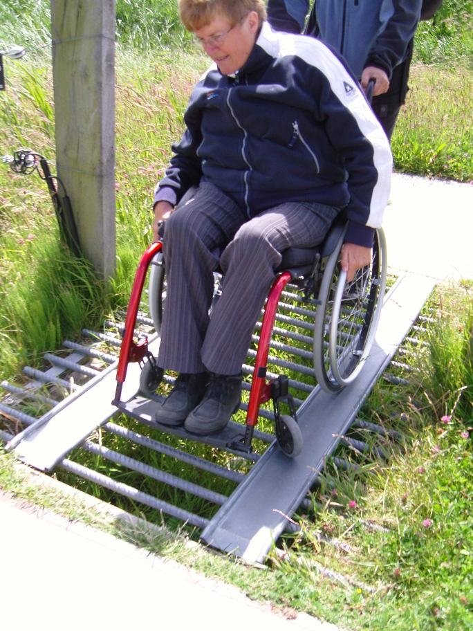 Er is een horizontaal blad voor de kijkopening aangebracht, waardoor deze plek gedeeltelijk onderrijdbaar is en de rolstoelgebruiker voorover kan leunen en heel ontspannen van het uitzicht kan