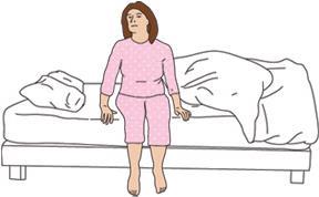 Laat de benen uit het bed zakken en duw u tegelijkertijd op met uw hand en elleboog.