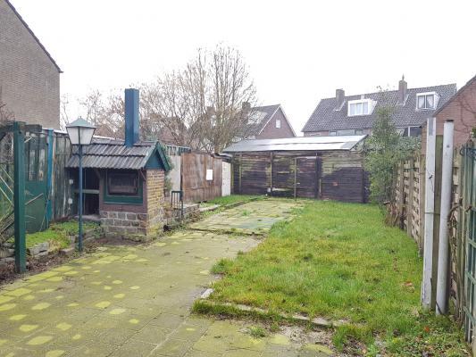 Omschrijving Ruime, te moderniseren tussenwoning met diepe tuin, 2 bergingen (garage mogelijk) en eigen oprit.